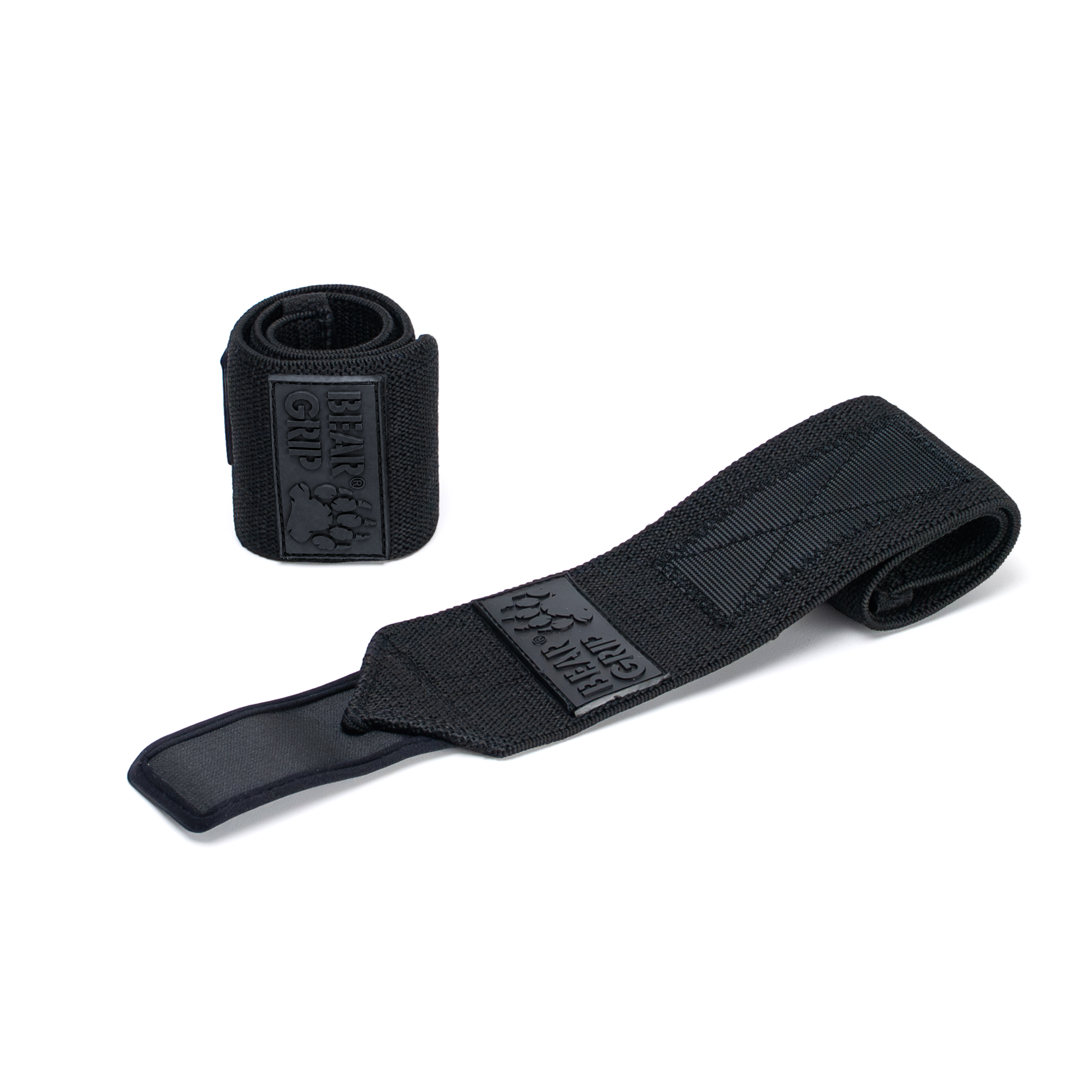 BEAR GRIP black wrist wraps, one upright and one laid flat, with textured straps and logo patch on a white background.